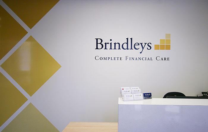 Brindleys reception area with business cards and logo on the back wall